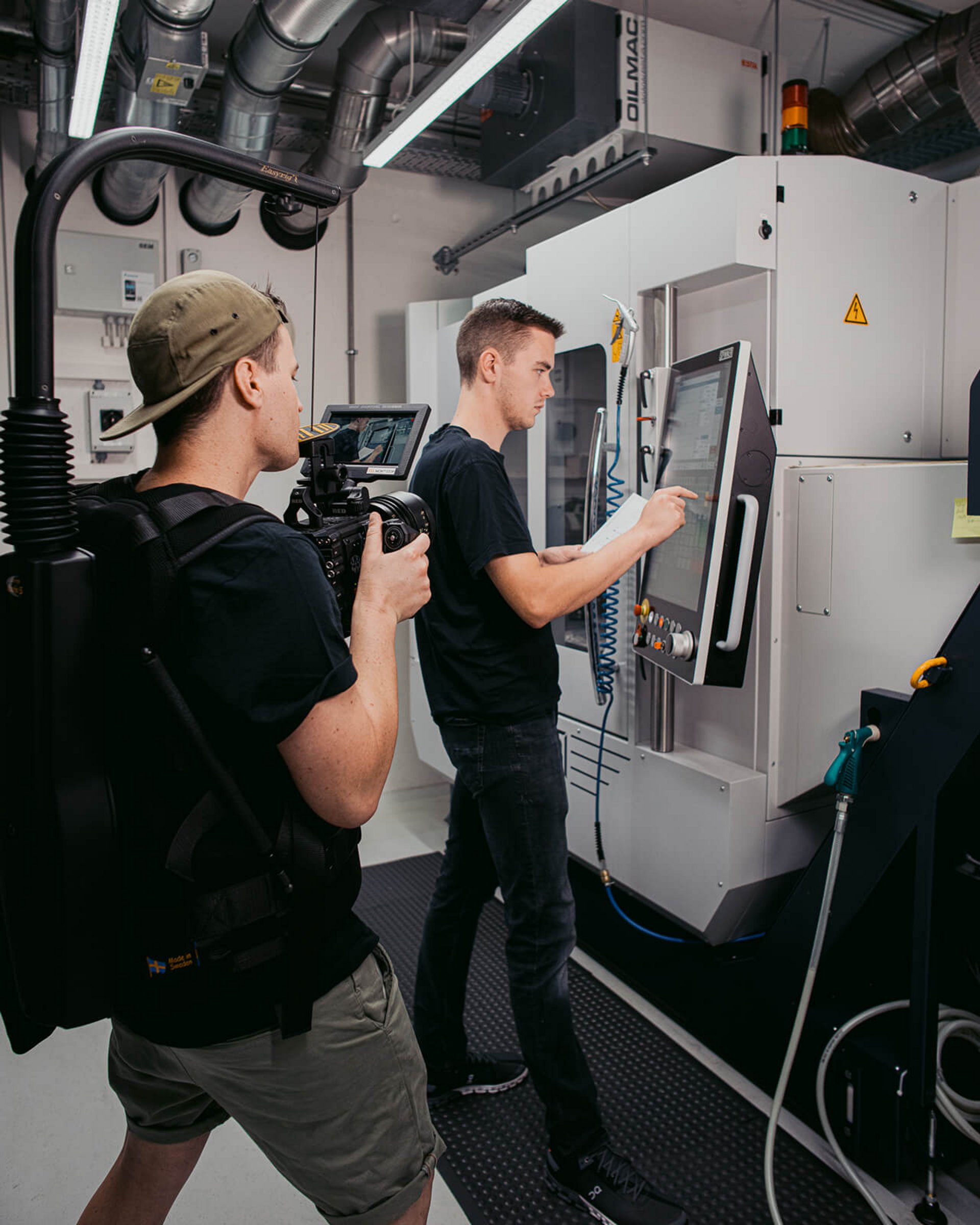 Sepp Morrison (Cameraman) filming an operator at a CNC machine during a corporate video shoot